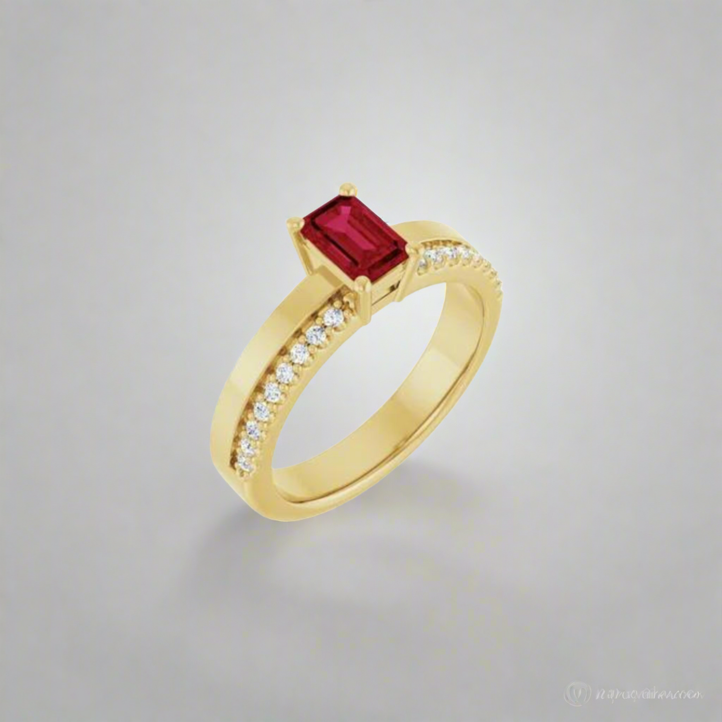 The Elyse Ruby Ring by Pear. boasts a gold band adorned with a rectangular step cut ruby as its focal point. Accentuated by 18 full cut diamonds on each side, this stunning ring offers a hint of sparkle against a light grey backdrop.