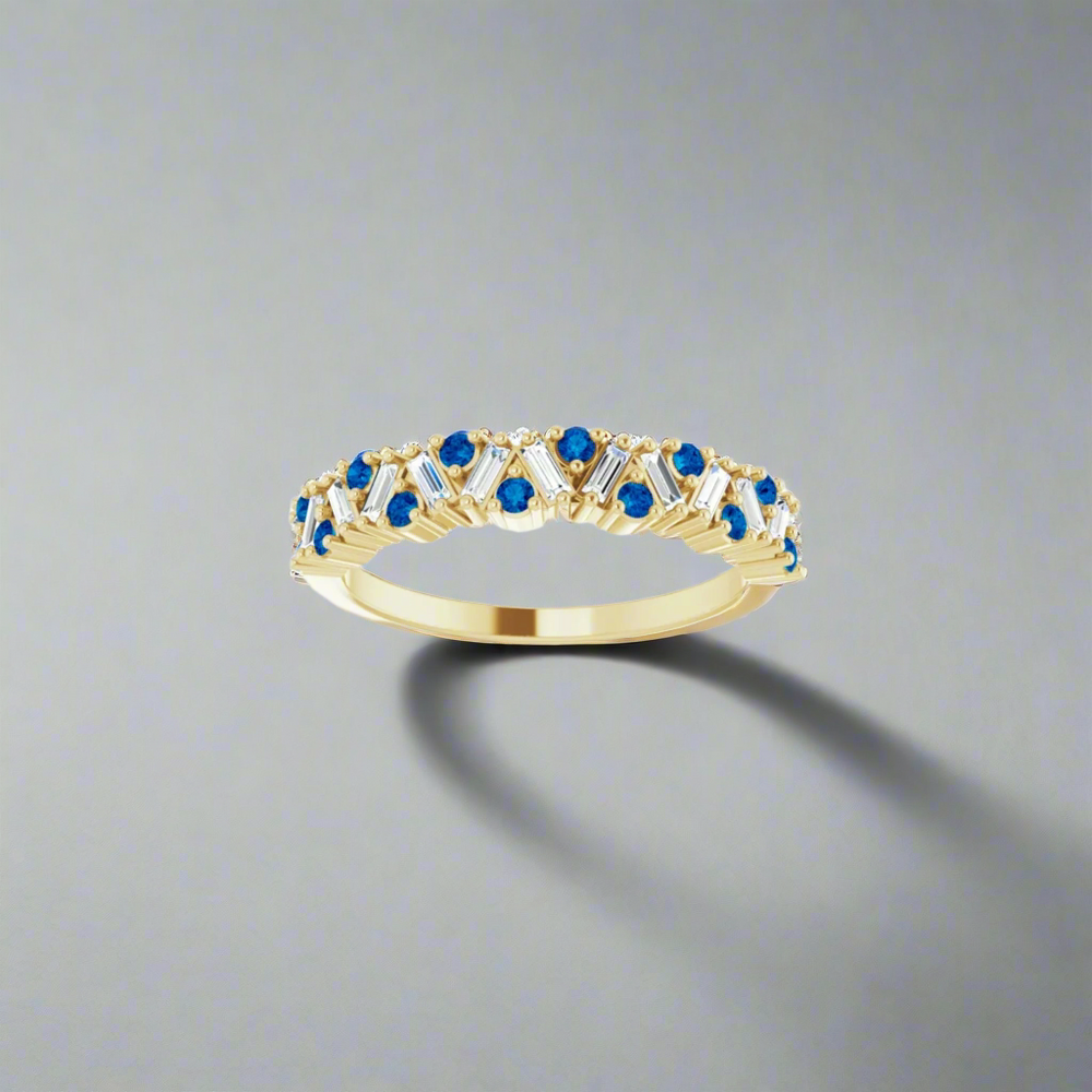 
                      
                        The Eloise Gemstone and Diamond Scattered Ring by Pear is a luxury ring, crafted from gold and adorned with a series of blue gemstones in a decorative pattern, set against a plain white background.
                      
                    