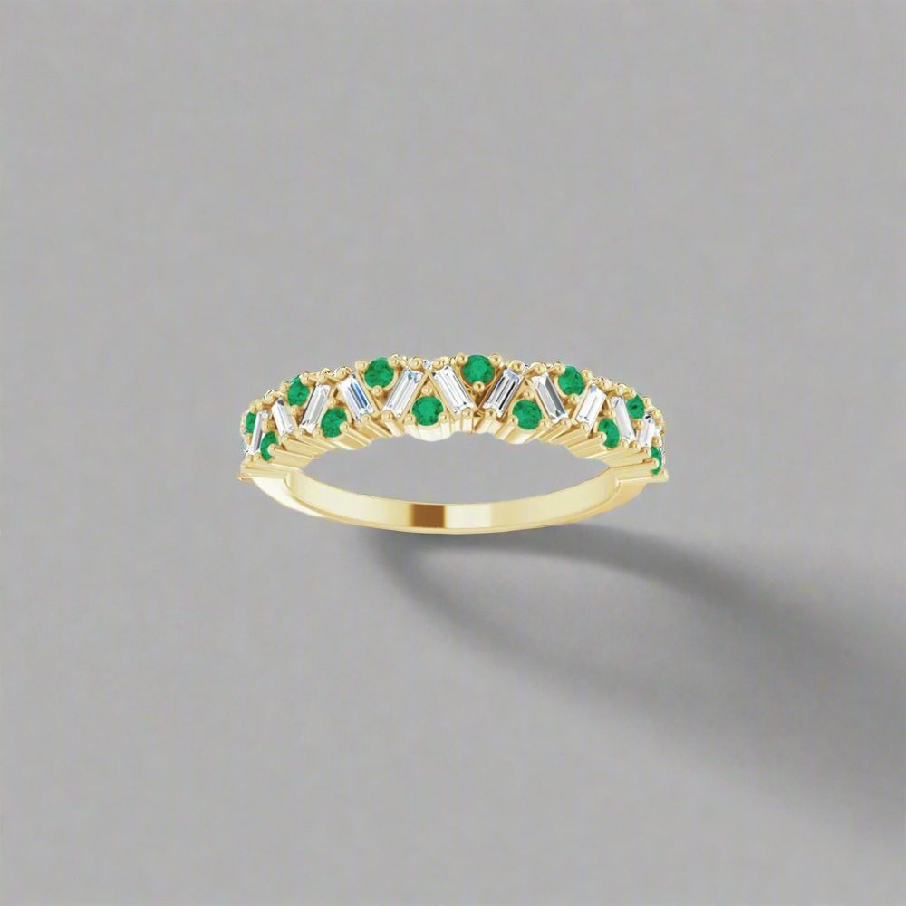 
                      
                        Introducing the Eloise Gemstone and Diamond Scattered Ring by Pear: a luxurious piece featuring a gold band embellished with small green gemstones and clear diamonds arranged in an elegant floral pattern, set against a simple gray backdrop.
                      
                    