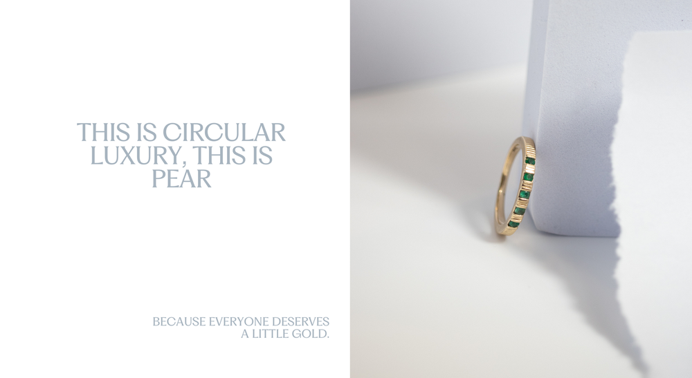 A gold ring with green inlays is standing vertically against a light-colored background and a sheet of torn paper. The text in the image reads, "This is circular luxury, this is PEAR" in large font and "Because everyone deserves a little gold." in smaller font.