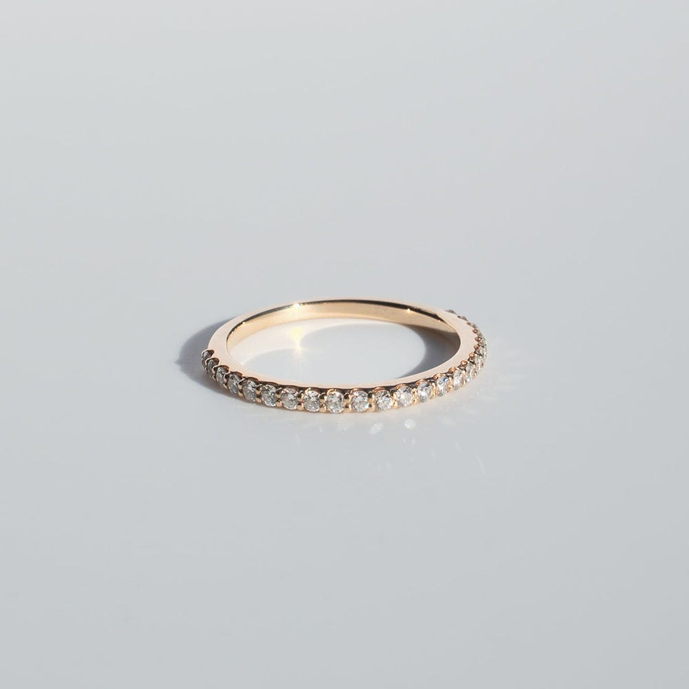 
                      
                        A delicate Diamond French Band from Pear., crafted from gold with a continuous series of small, sparkling diamonds, is displayed against a clean, light gray background. The ring's simple yet elegant design is highlighted by the radiant sparkle of the diamonds.
                      
                    