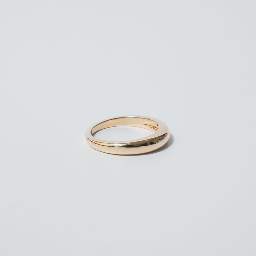 
                      
                        The Dome Ring by Pear is a simple, elegant gold ring made from 14K Yellow Gold with a smooth, polished surface, showcased against a plain light gray background. Ideal for daily layering, the ring features a slight curve with no intricate detailing.
                      
                    