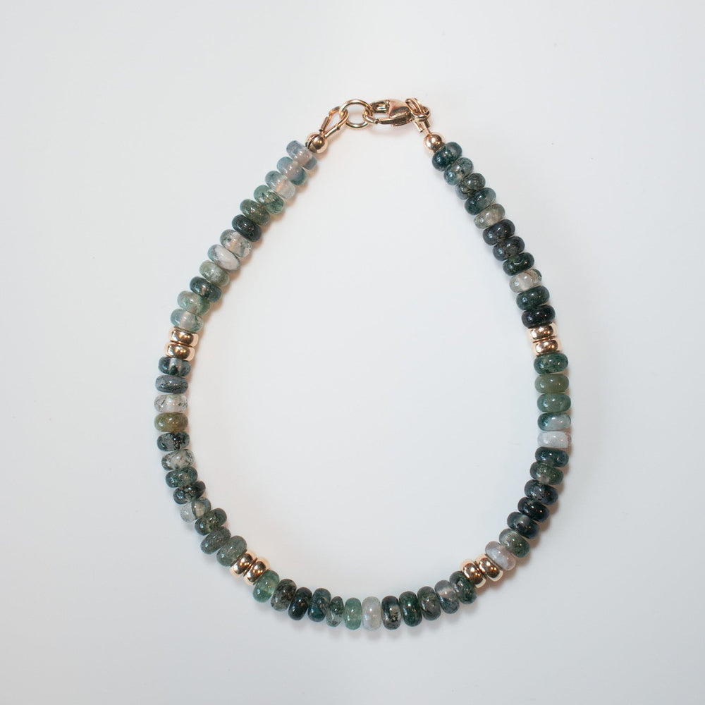 The Agate and Gold Bead Bracelet by Pear. elegantly combines shades of green and gray agate stones with delicate gold spacer beads, forming a seamless loop against a plain white background.