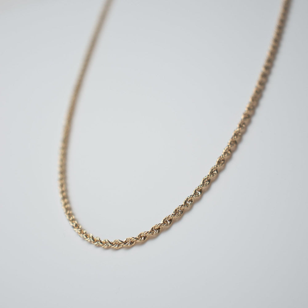 
                      
                        A close-up image of a 14K yellow gold necklace against a plain white background showcases the delicate beauty of this Pear. Round Rope Chain. The twisted design highlights its finely crafted elegance.
                      
                    