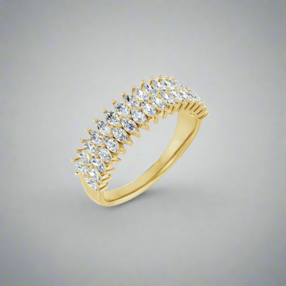 A captivating 1 CTW Double Marquise Ring by Pear., crafted from solid 14K gold, features a row of natural marquise diamonds set in an overlapping pattern. The stunning design is beautifully showcased against a simple, gradient gray background.