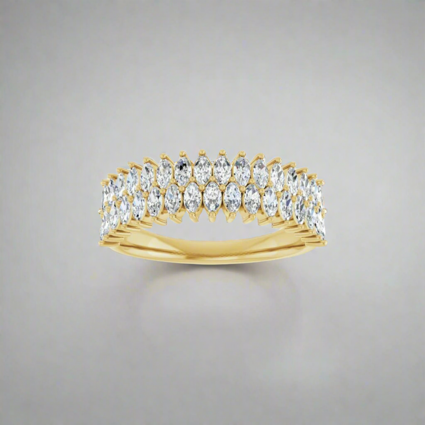 The Pear 1 CTW Double Marquise Ring features two rows of natural marquise diamonds set in a symmetrical pattern. Its polished finish and glittering diamonds stand out against the light grey background, showcasing its elegant design.